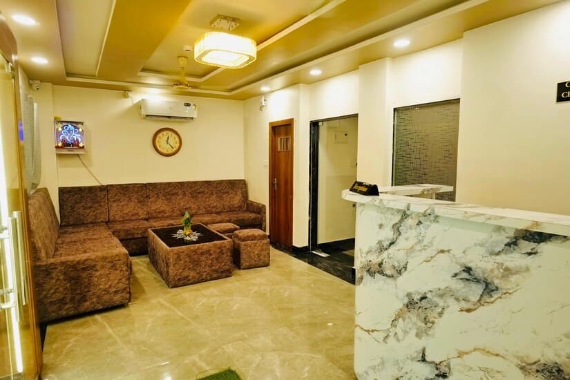 Hotel lobby with a marble reception desk and sofa seating